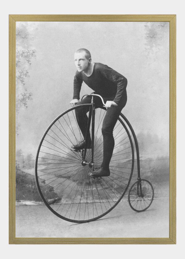 MAN POSEING ON HIS BICYCLE