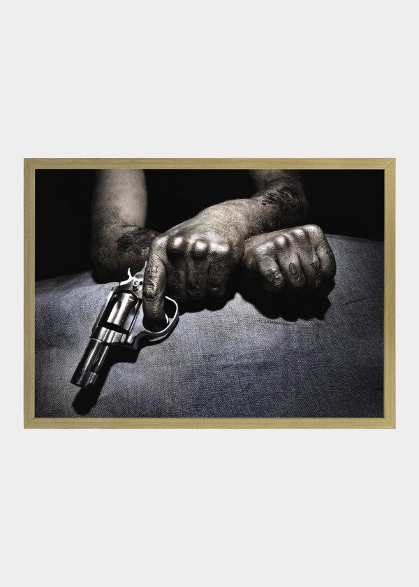 TATTOOED MAN WITH REVOLVER