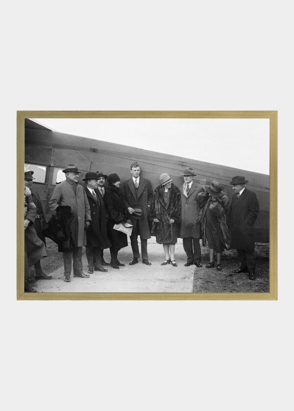 CHARLES LINDBERGH AND GROUP NEXT TO AIRPLANE.1928