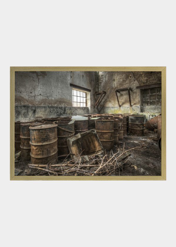 RUSTY BARRELS STORED IN AN ABANDONED FACTORY