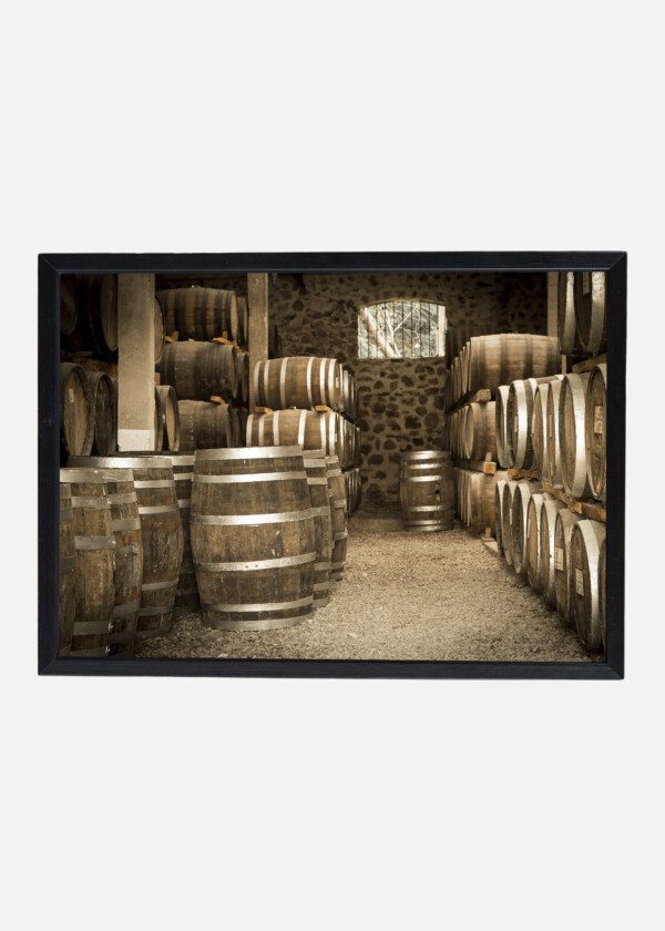 WINE BARRELS STORED IN AN OLD CELLAR AT A WINERY
