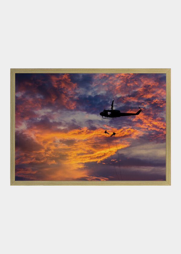 HELICOPTER AGAINST RED SKY