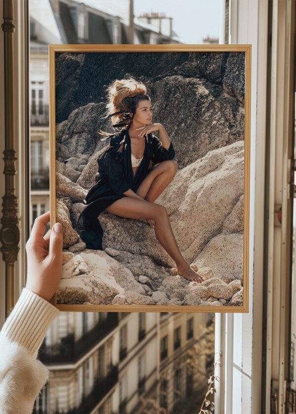 MODEL SITTING ON ROCKS