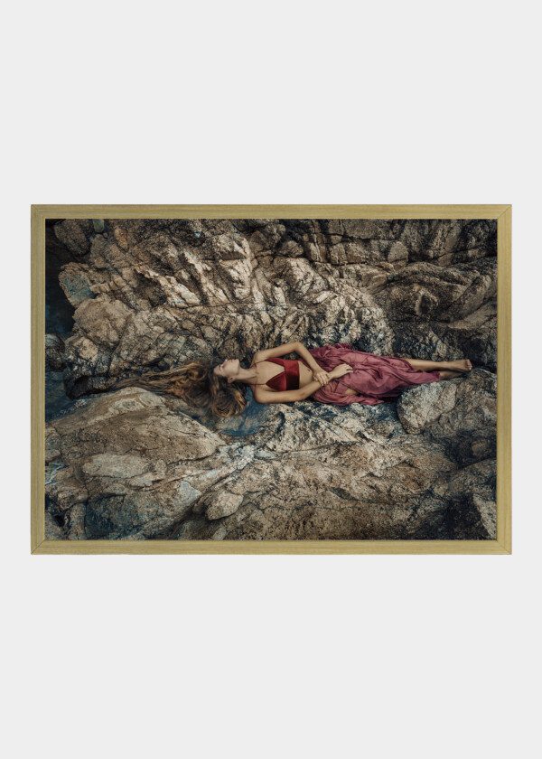 MODEL LYING ON THE ROCK