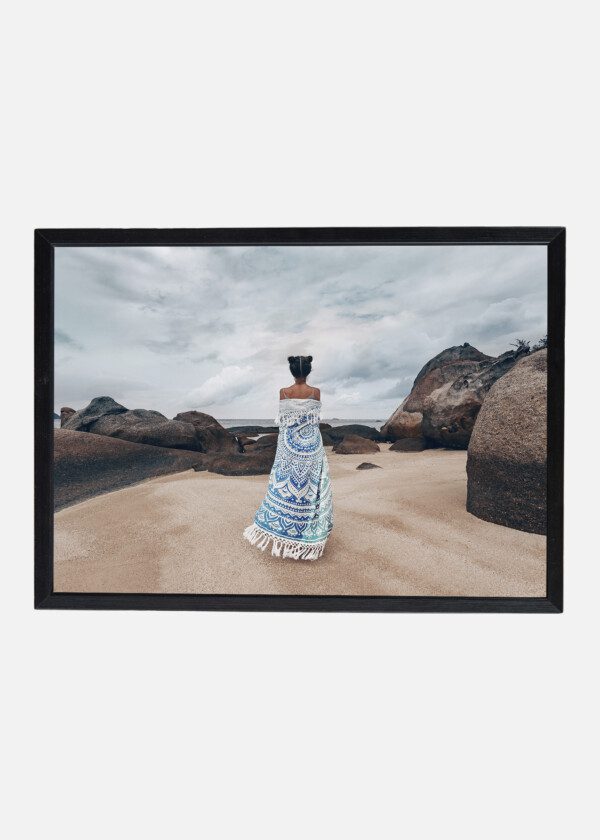 BEAUTIFUL YOUNG WOMAN COVERED WITH SHAWL ON THE BEACH