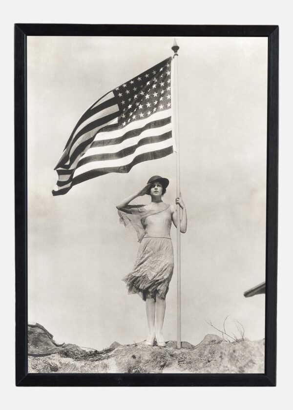 PATRIOTIC WOMAN HOLDING AMERICAN FLAG AND SALUTING