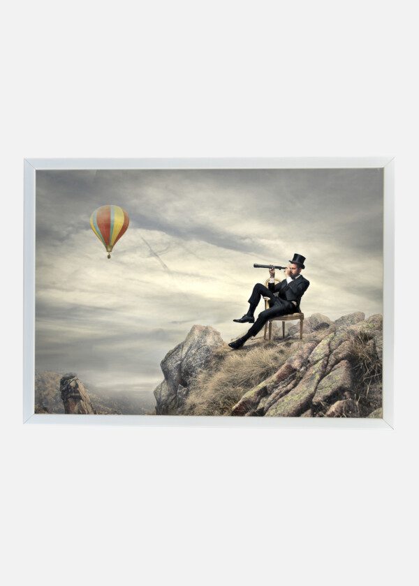 RICH BUSINESSMAN SITTING ON A CHAIR IN THE MOUNTAIN LOOKING THE LANDSCAPE WITH SPYGLASS