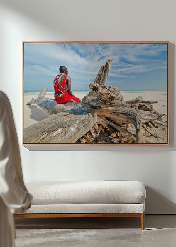 MAN OF THE MAASAI TRIBE SITS ON THE SHORE OF THE INDIAN OCEAN