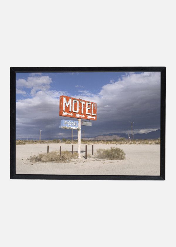 AN OLD SIGN OVERLOOKING UNDEVELOPED DESERT LAND