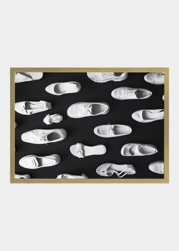 MANY DIFFERENT WHITE SHOES ON A BLACK BACKGROUND