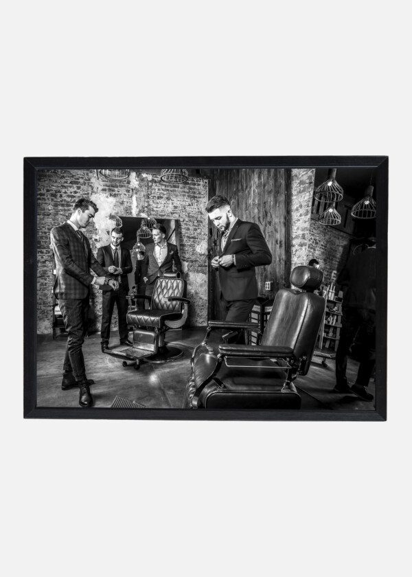 GROUP OF YOUNG ELEGANT POSITIVE MENS POSE IN INTERIOR OF BARBERSHOP. BLACK-WHITE PHOTO