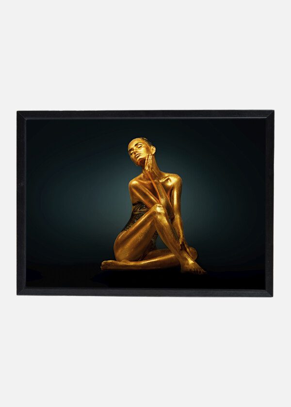 HIGH FASHION MODEL GIRL WITH BRIGHT GOLDEN SPARKLES ON HER BODY POSING