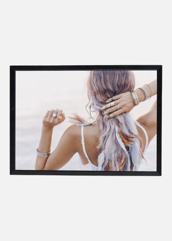 BEAUTIFUL YOUNG BOHO WOMAN CLOSE UP WITH PINK FEATHERS AND ACCESSORIES AT SUNSET