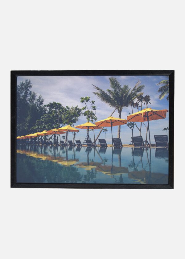 BEAUTIFUL VIEW OF ROW OF YELLOW BEACH UMBRELLAS AND BEACH BED IN FRONT OF THE LUXURY SWIMMING POOL