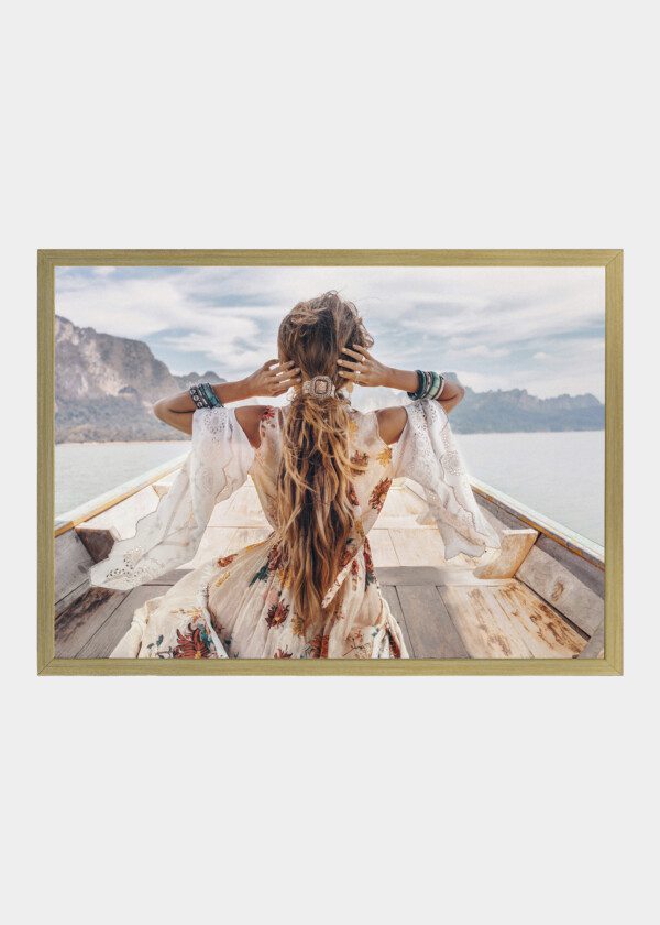 FASHIONABLE YOUNG MODEL IN BOHO STYLE DRESS ON BOAT AT THE LAKE